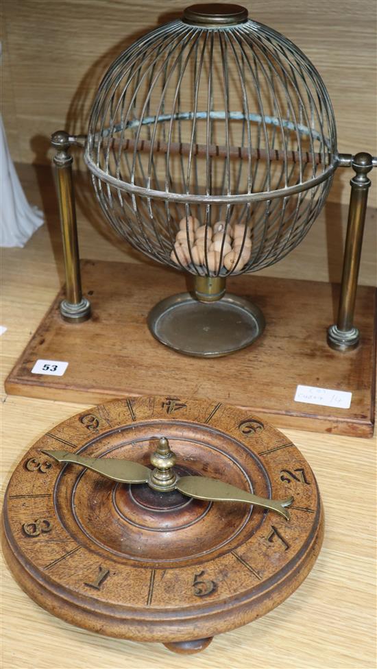 A late 19th century/early 20th century brass tombola cage and an early roulette wheel